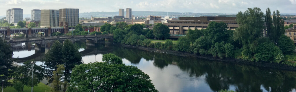 Glasgow: river, trees, and buildings.